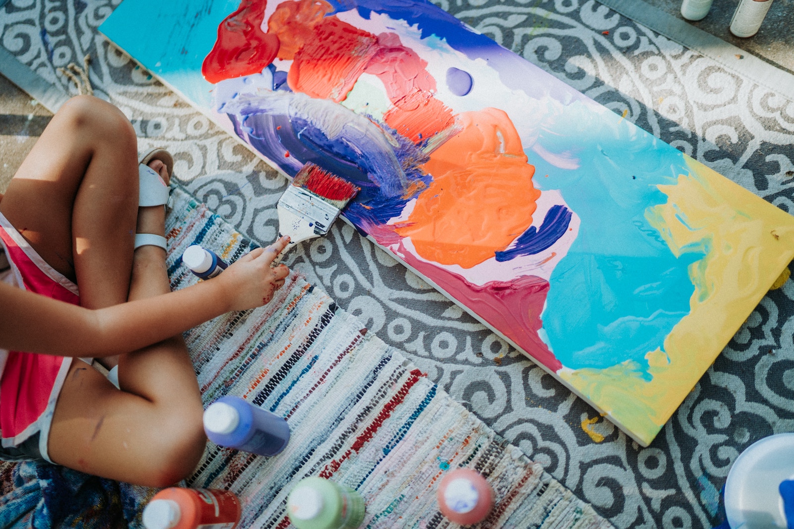 A young child painting creatively.