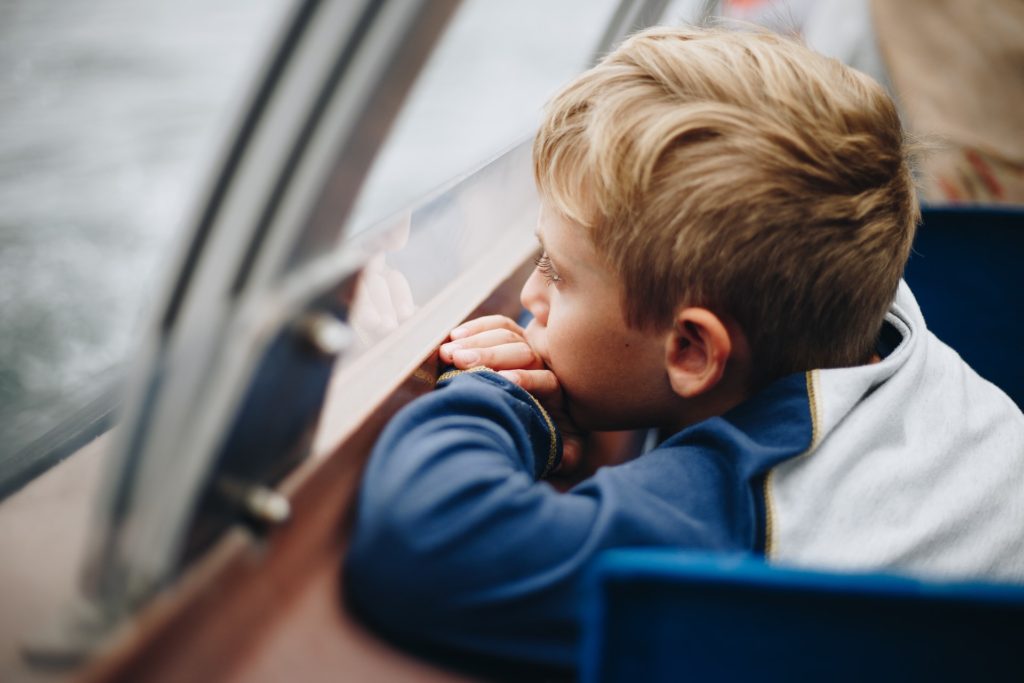 A child looks out the window. Building resilience in kids.