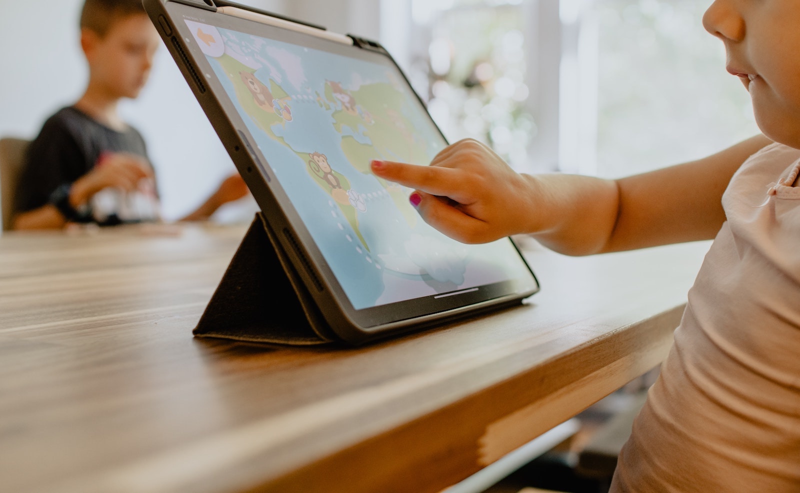 Young child doing homework on a tablet computer