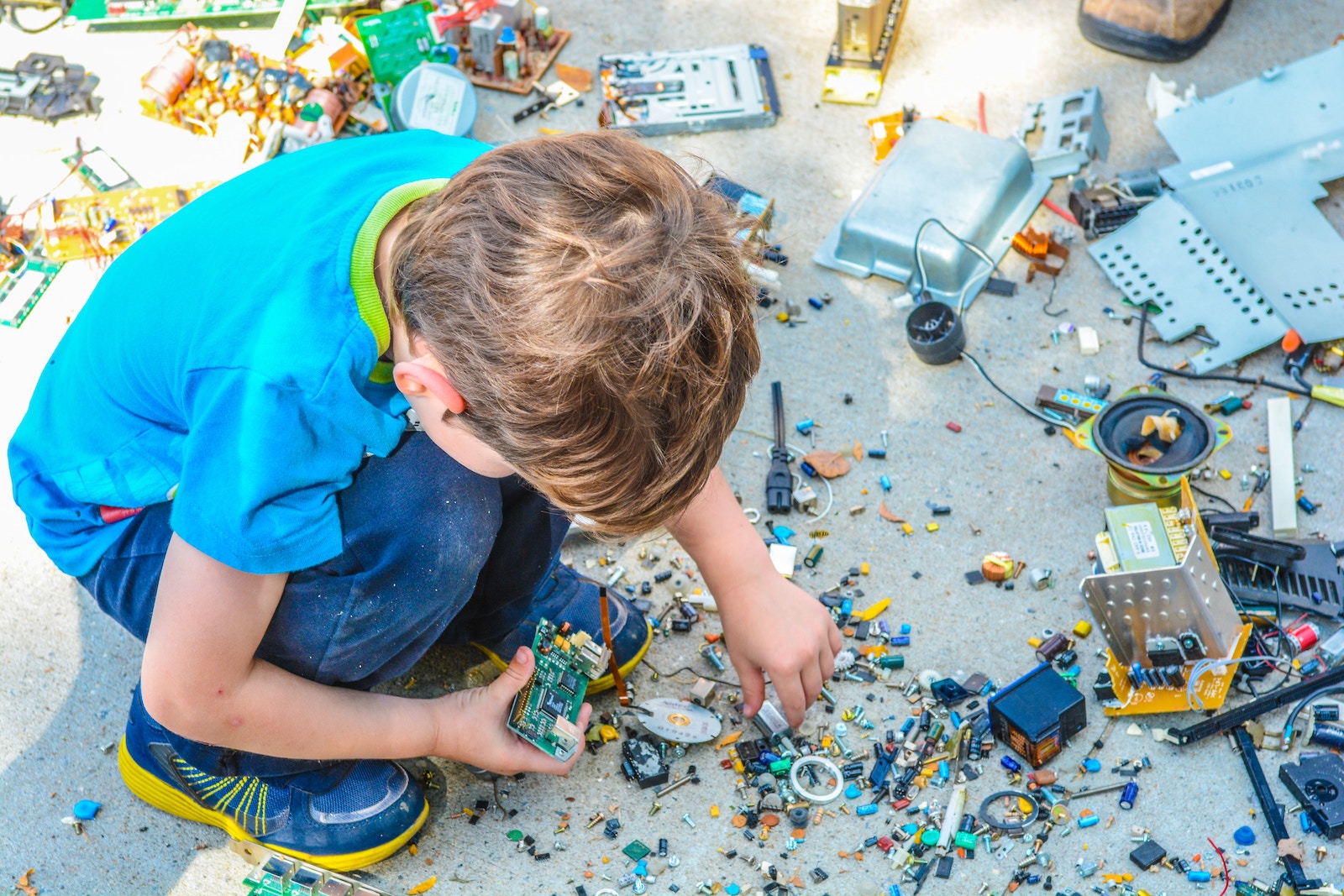 A child plays with electronic pieces, developing life skills