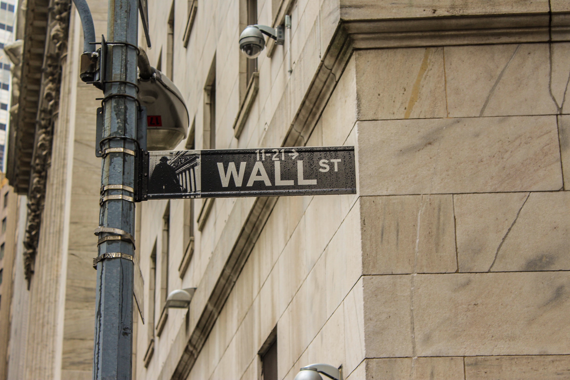 A Wall Street sign. Ray Dalio's upbringing and rise to success